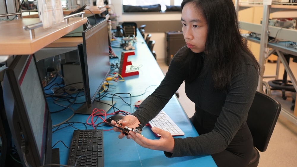 A student works with computer engineering equipment in the lab.