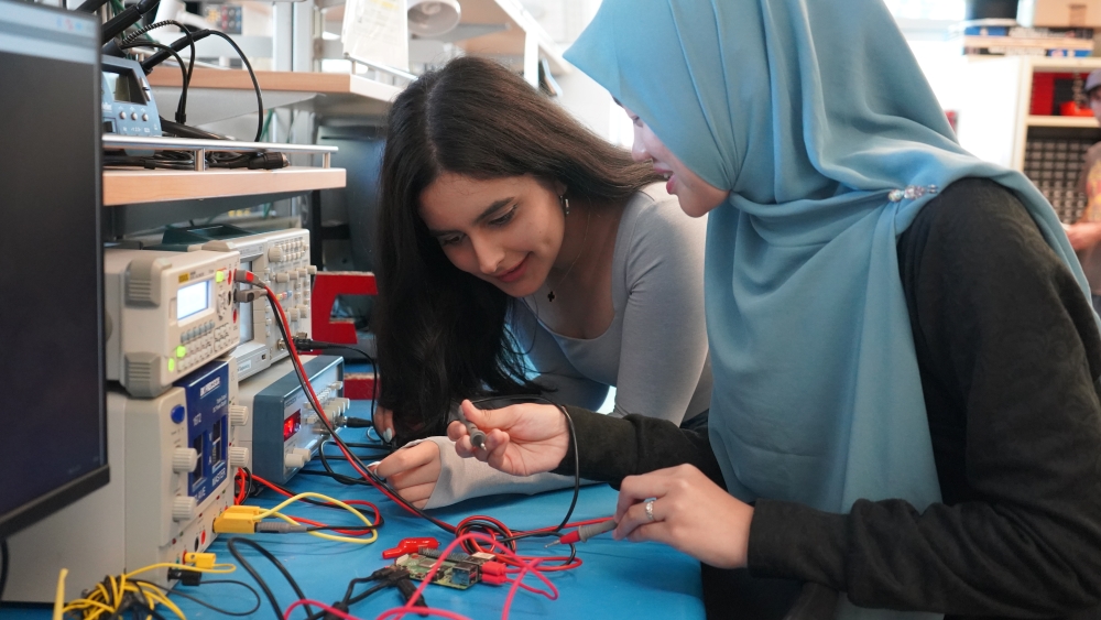 Two students work with equipment in the Electrical Engineering lab.