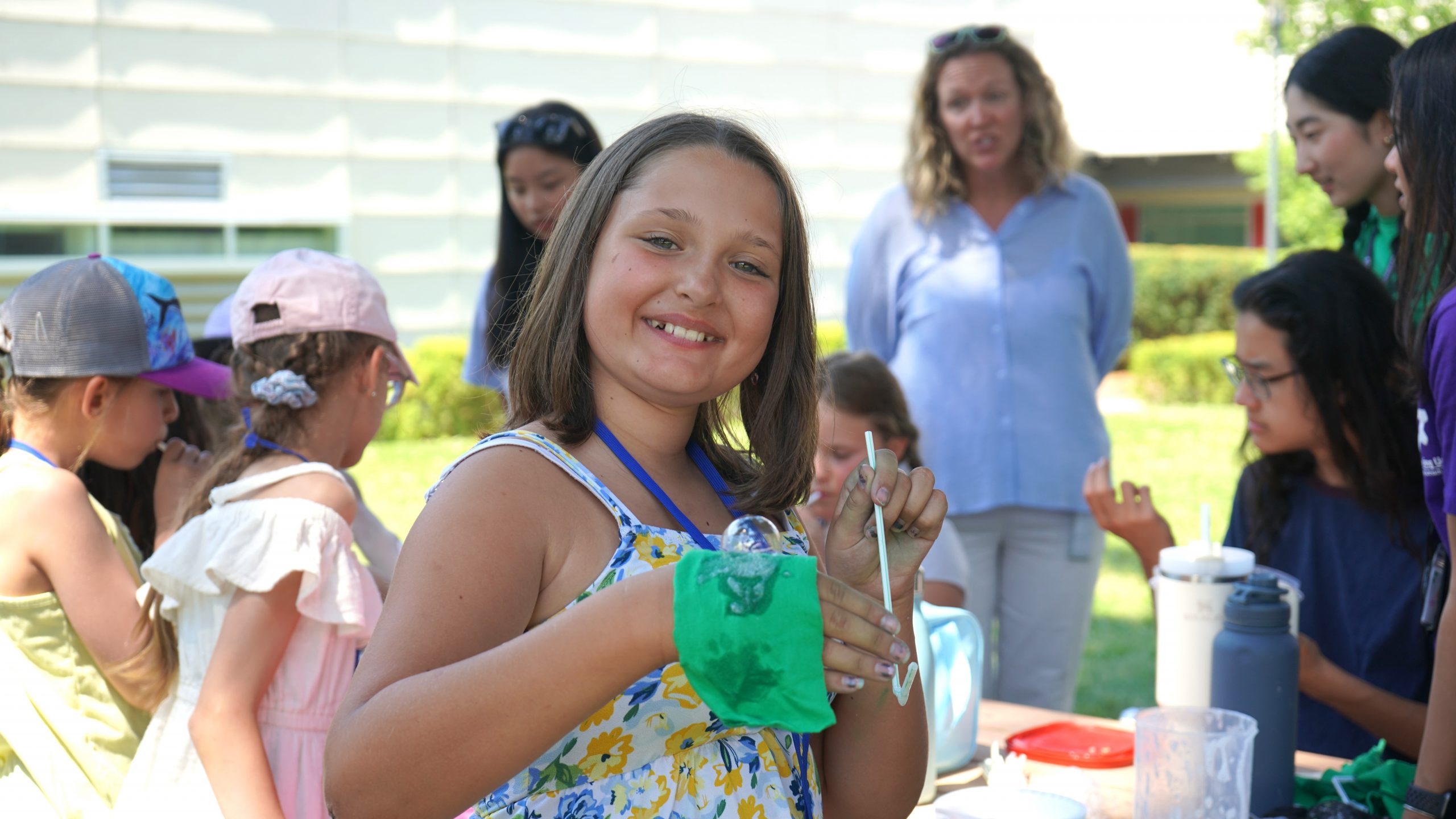 kid looking at camera while other kids play in the background