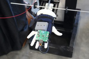 face down mannequin hand with tremor monitor in centre of hand