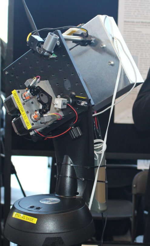 man beside laser pointing apparatus