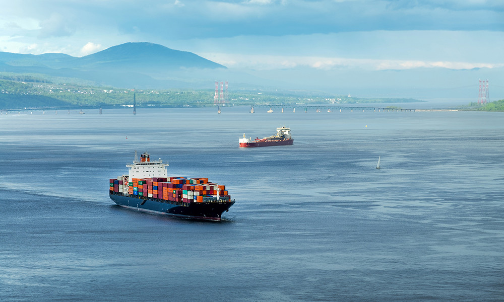 a cargo ship, loaded with containers is seen moving into port