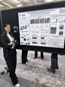 Mojdeh at a conference beside her research
