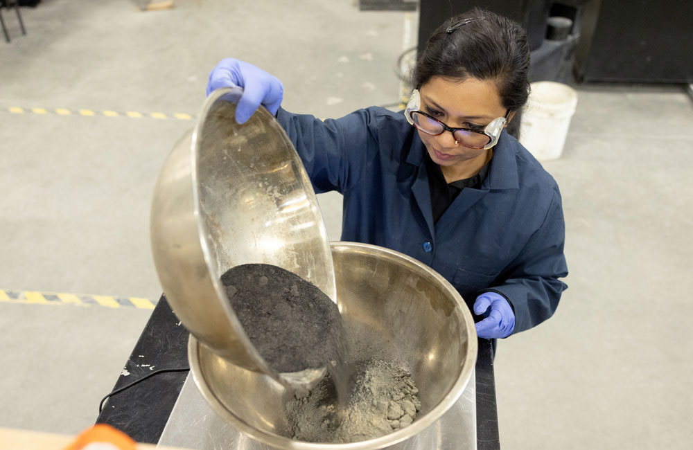 woman pouring concrete into a bowl