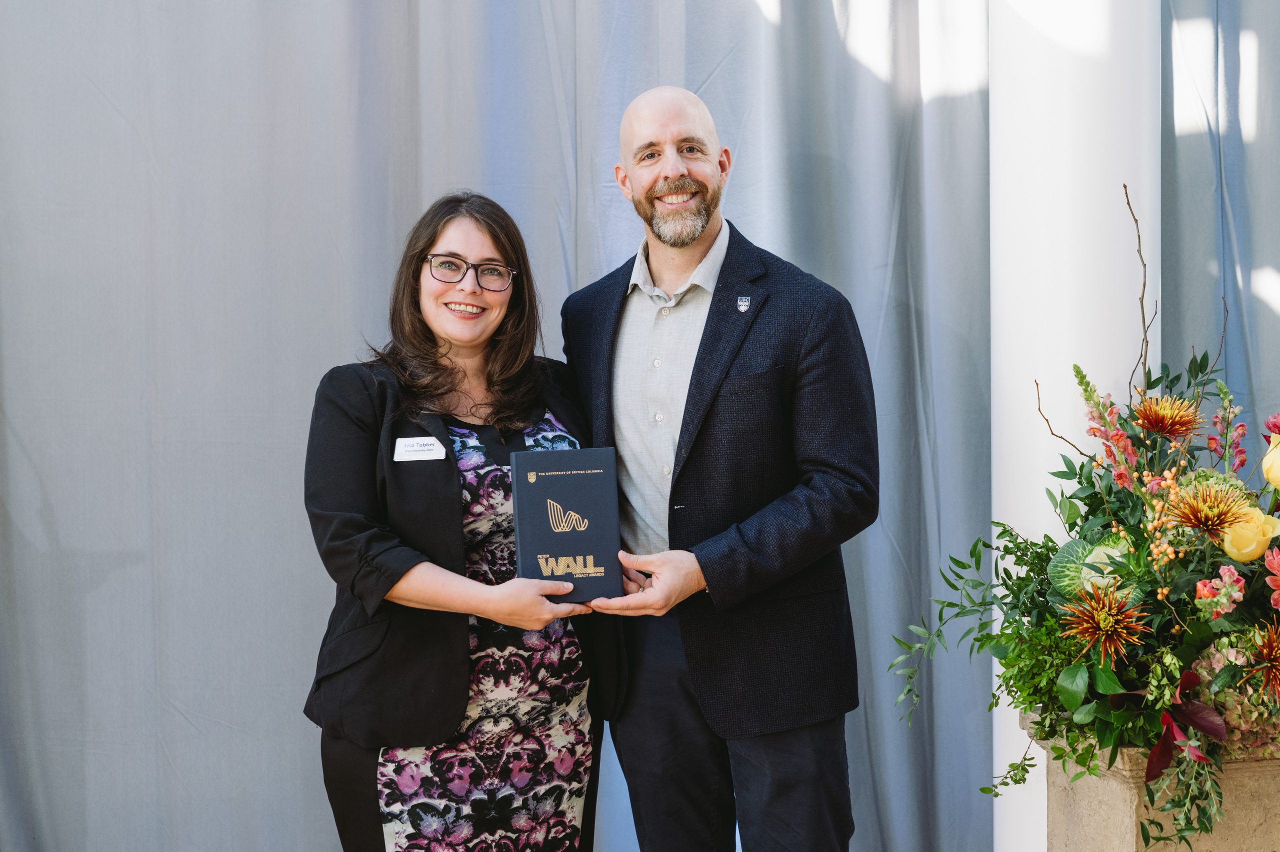Dr. Tober and Dr. Bacon standing together with a plaque.