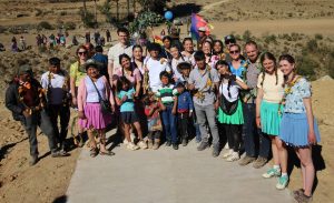 The engineers who built the bridge standing with some of the villagers